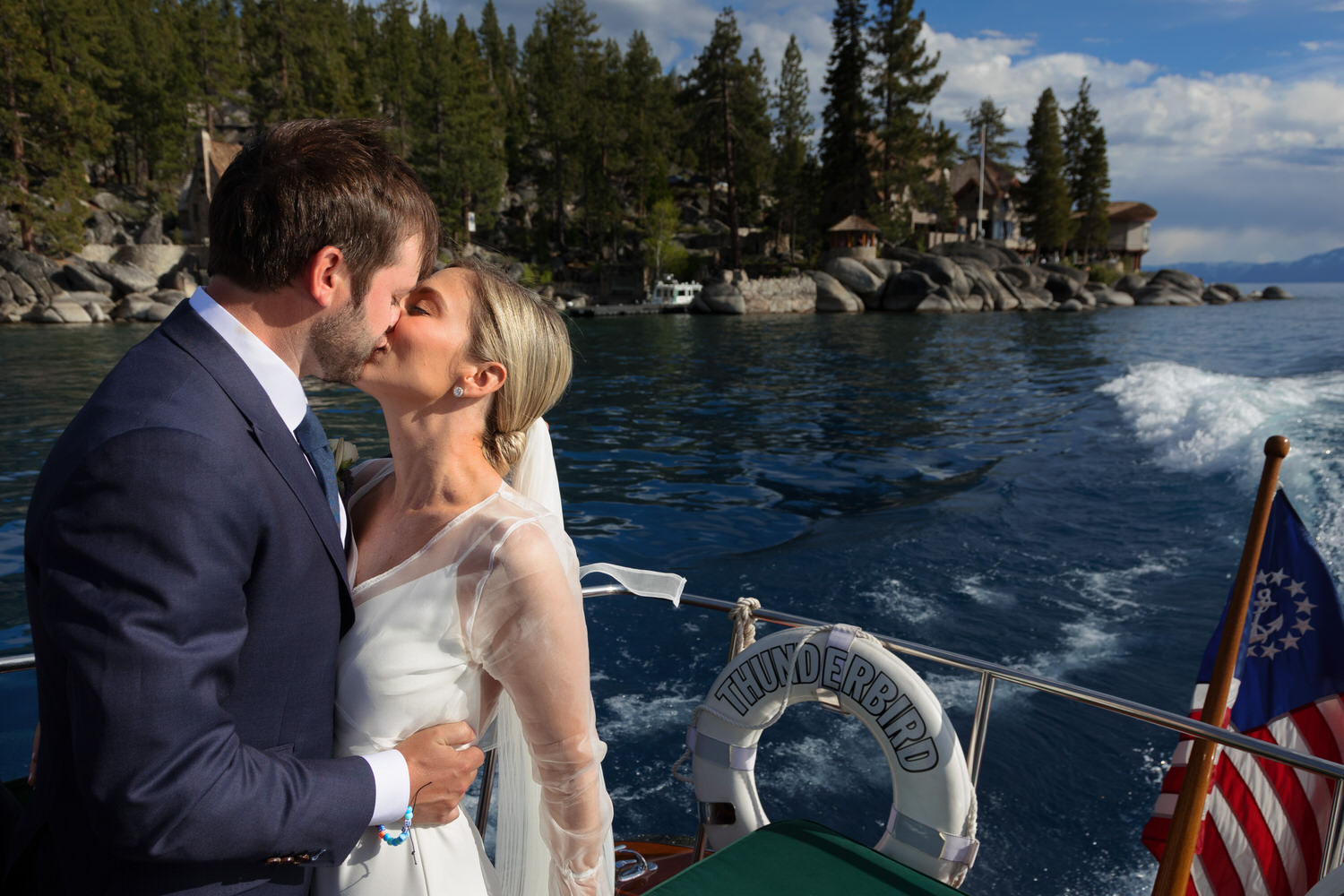 A bride and groom enjoy a romantic boat ride on Lake Tahoe after their wedding.