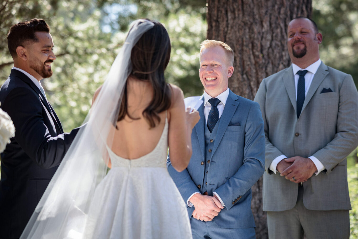 A groom wearing a grey blue suit that is perfect for a summer wedding in Lake Tahoe.