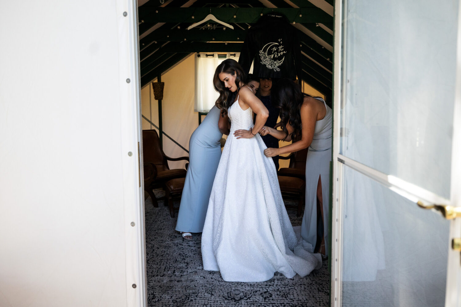 Bride getting ready in the small white tent cabin at Dancing Pines.