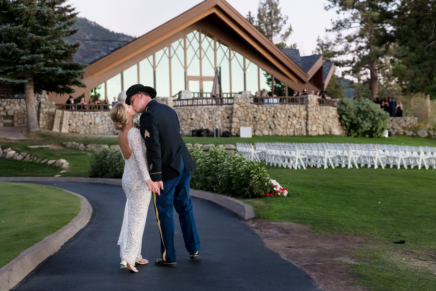 A bride and groom enjoy a romantic sunset kiss in front of the North Lawn at Edgewood Tahoe Resort.
