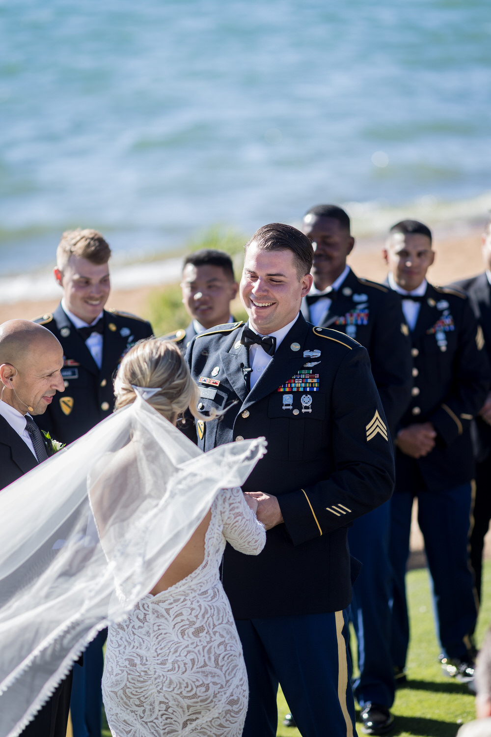 A groom in dress blues reads vows to his bride at a Lake Tahoe military wedding.