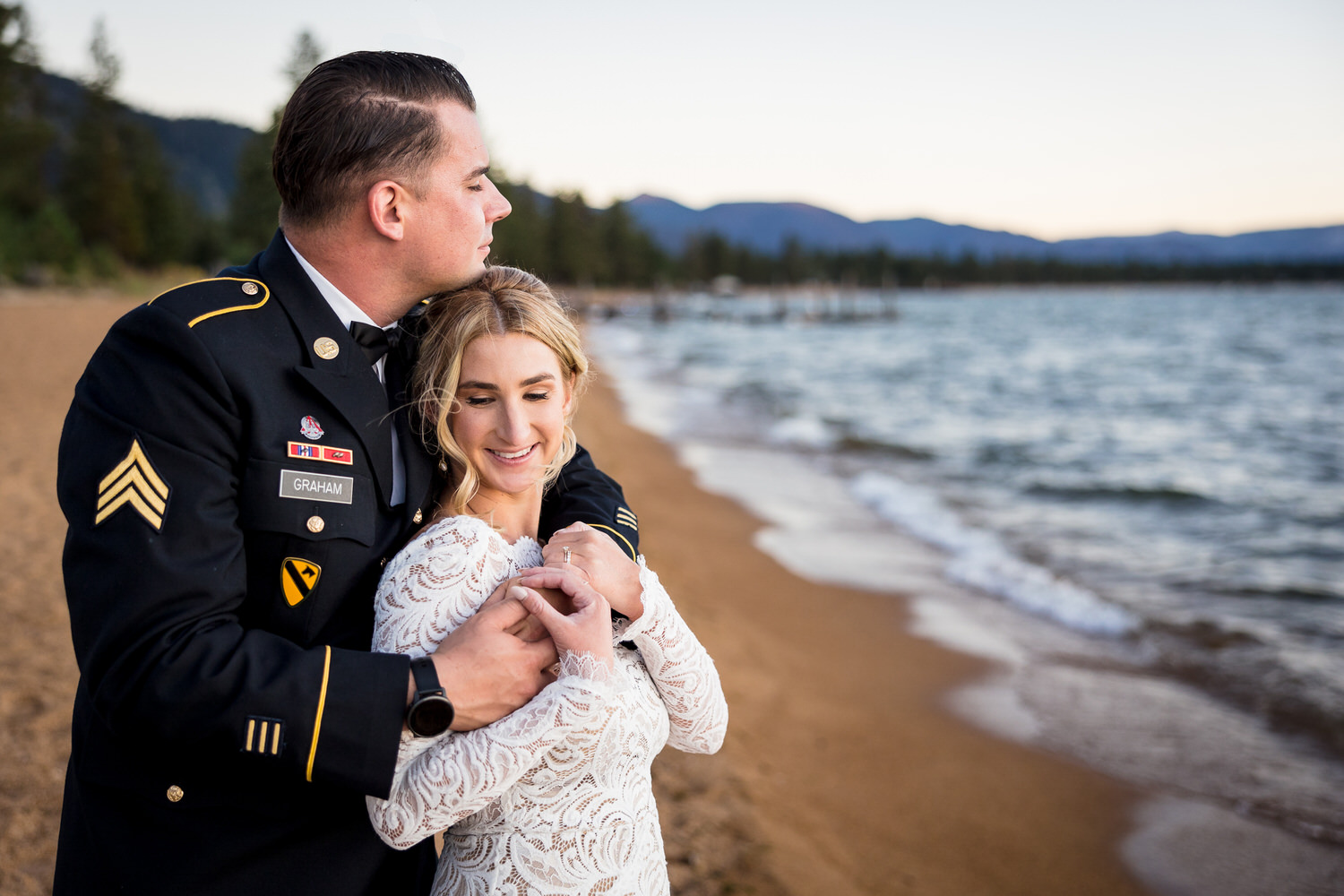 Sunset lakeside portrait of a bride and groom at a South Lake Tahoe military wedding.