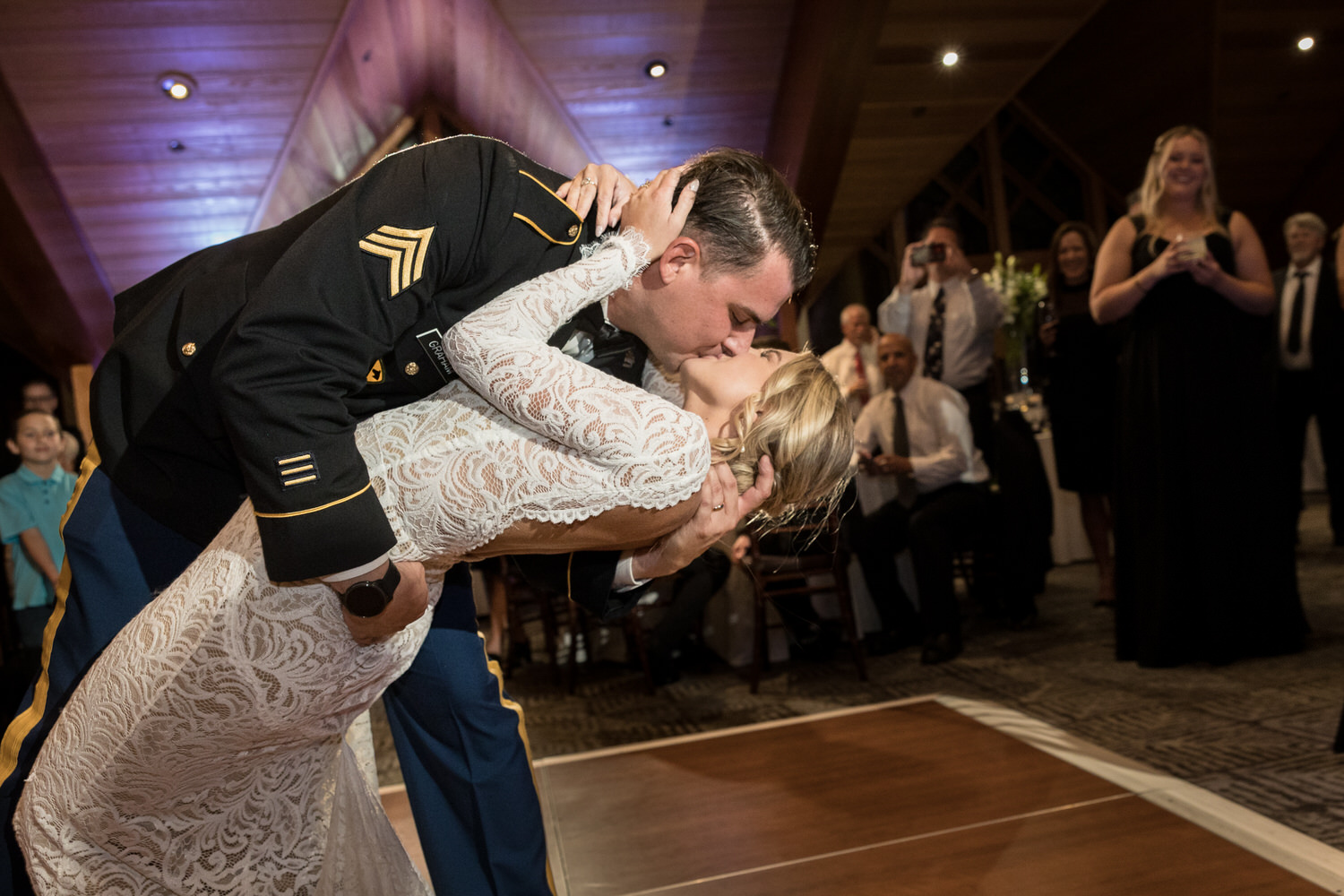 A romantic dip and kiss for a bride  and groom on the dance floor at a North Room wedding reception.