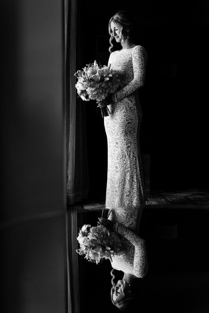 Classic black and white portrait of a bride reflected in a glass tabletop at the Edgewood Suite.