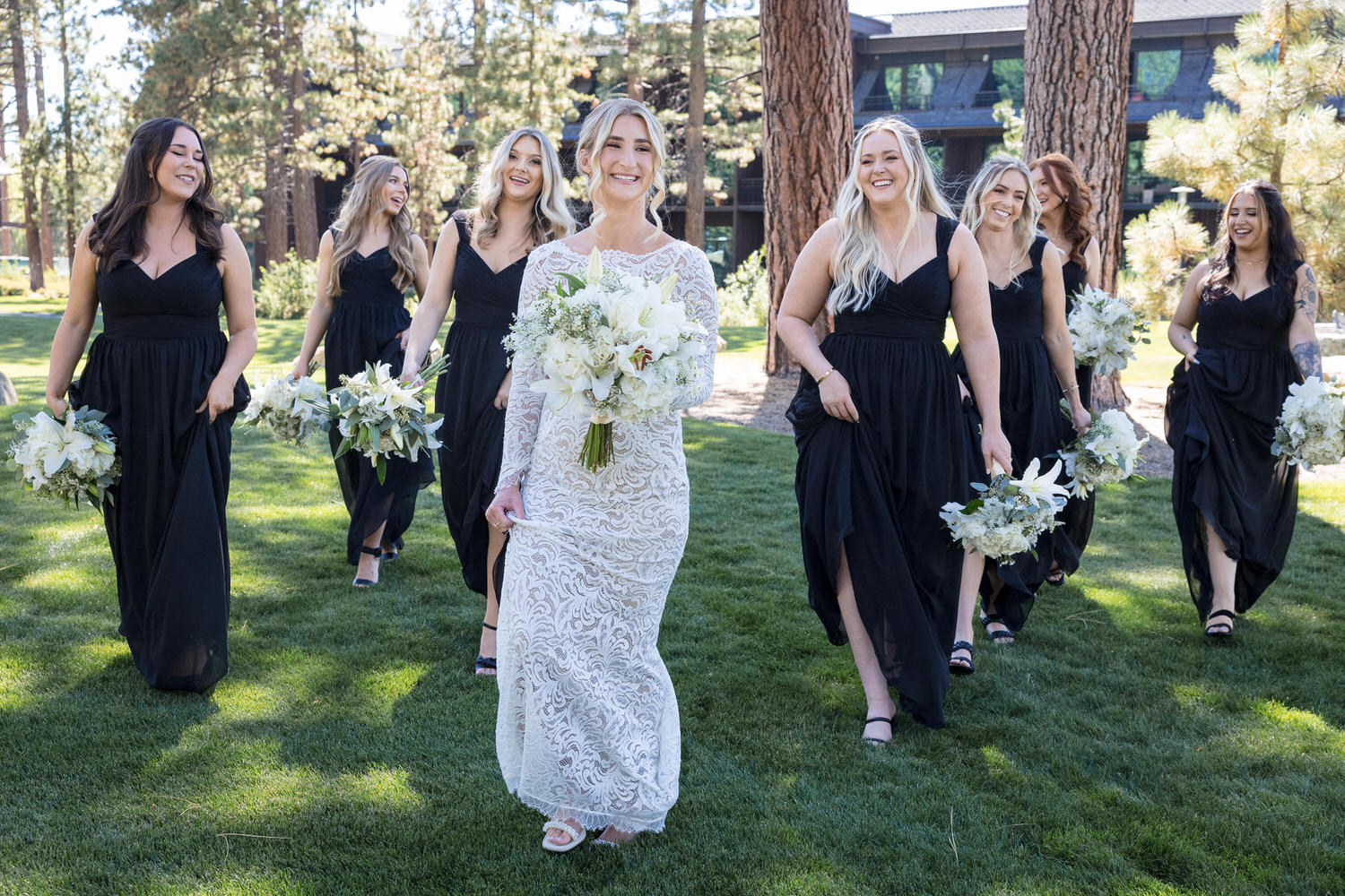 Bridesmaids accompany a bride across the lawn at a photo-permitted area at Edgewood Tahoe Resort.