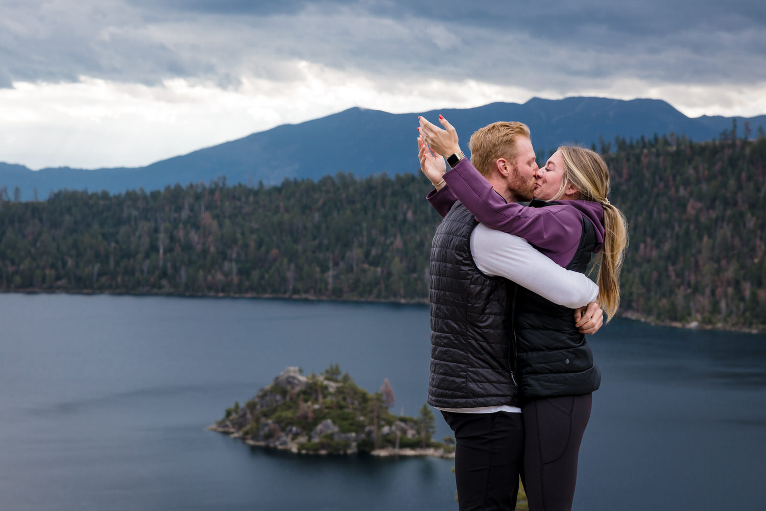 A sweet kiss for a newly-engaged couple at a picturesque engagement location next to Lake Tahoe.