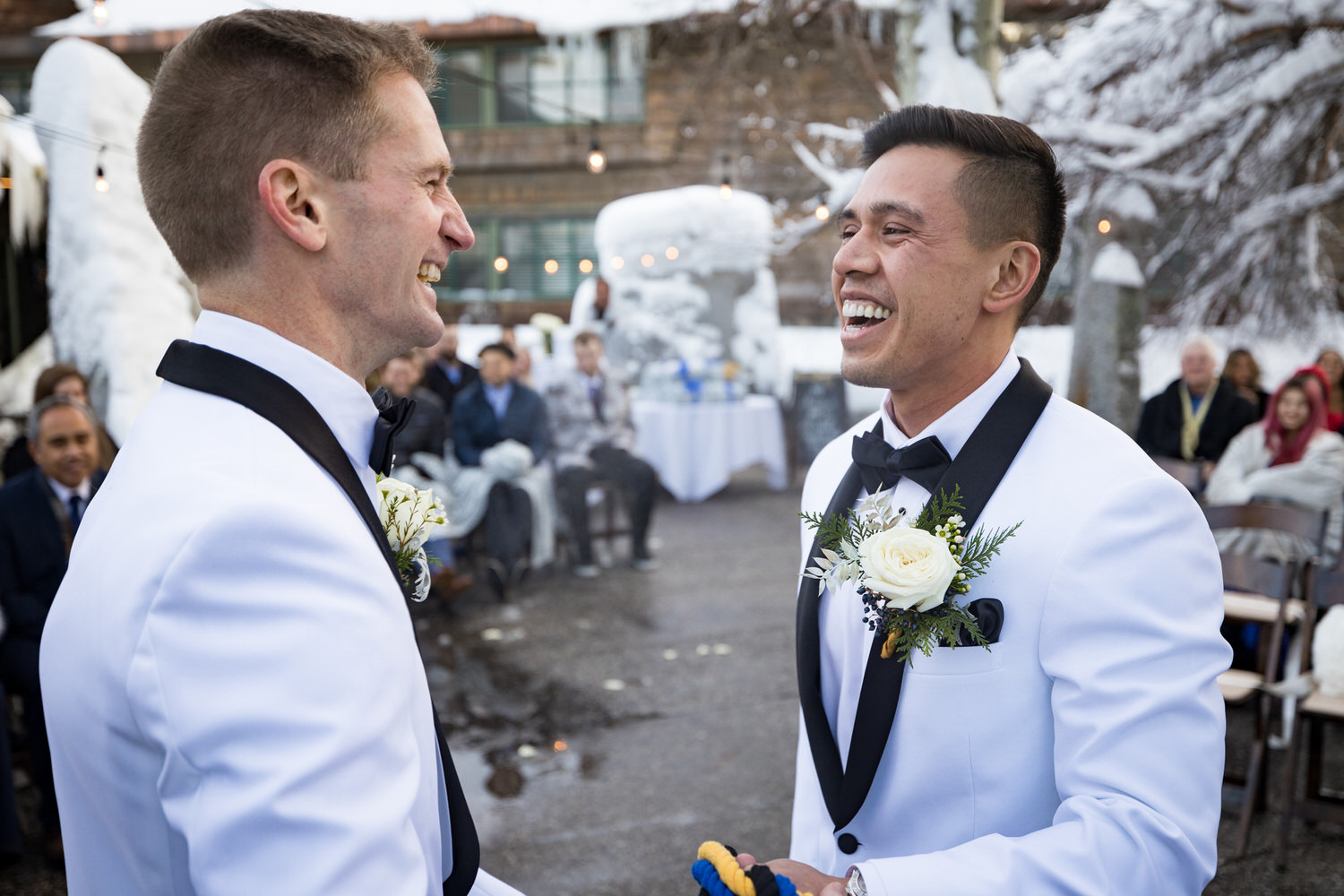 Two grooms that decided to get married during winter in Lake Tahoe enjoy a sweet moment during their ceremony.