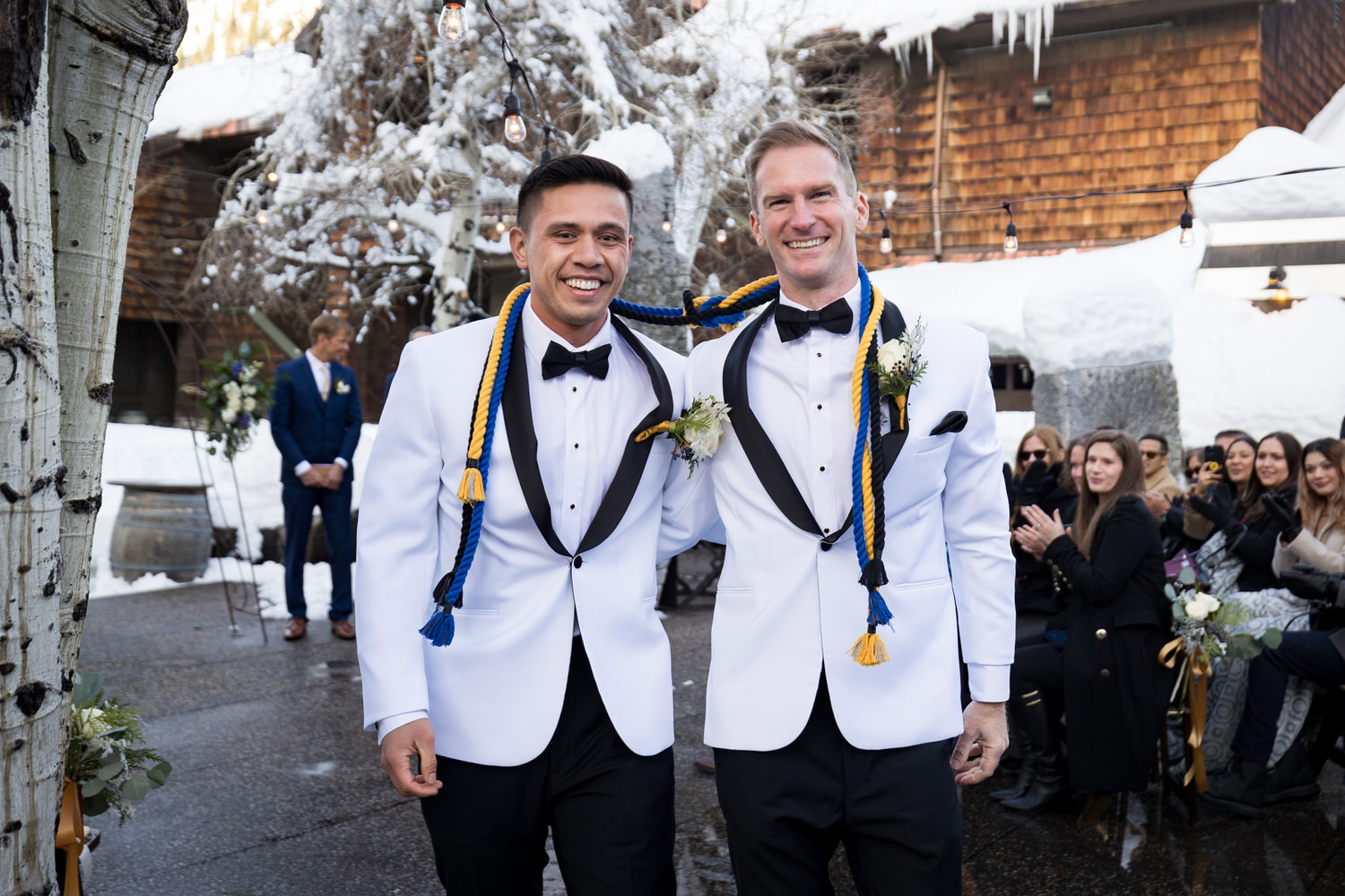 Gay wedding ceremony with two grooms in Olympic Valley.