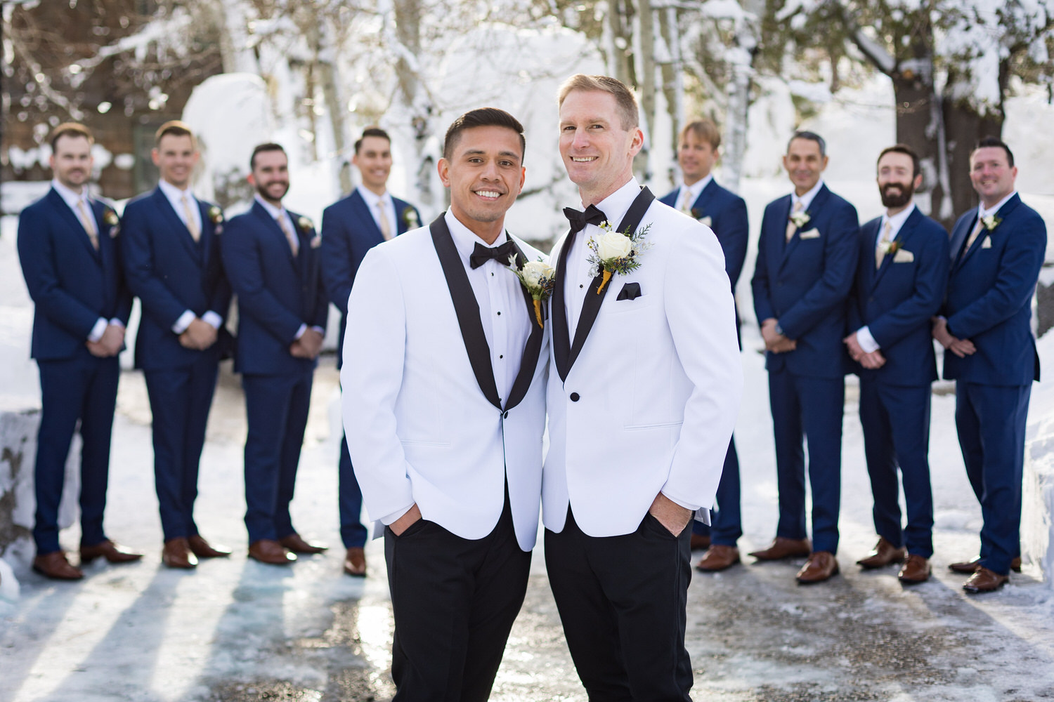 Two grooms and their wedding party at a PlumpJack Inn winter portrait location.