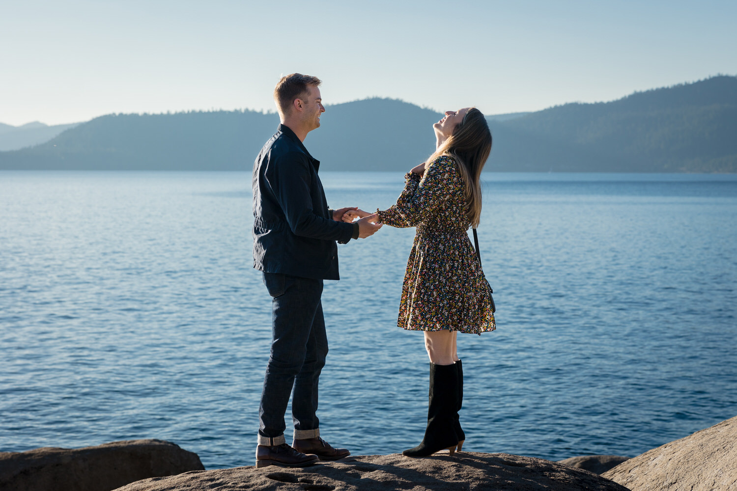 A man surprises his girlfriend at their private wedding proposal at a beautiful lakeside location near Lake Tahoe.