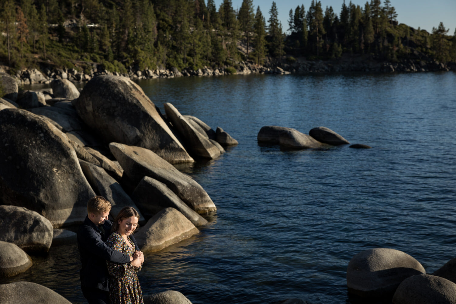 Afternoon surprise wedding proposal and engagement photos on the rocky eastern shore of Lake Tahoe.