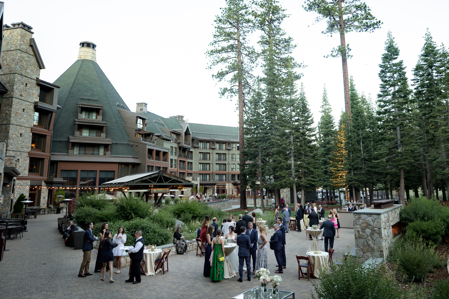 Wide angle view of wedding guests enjoying cocktail hour at the Fireside Terrace.