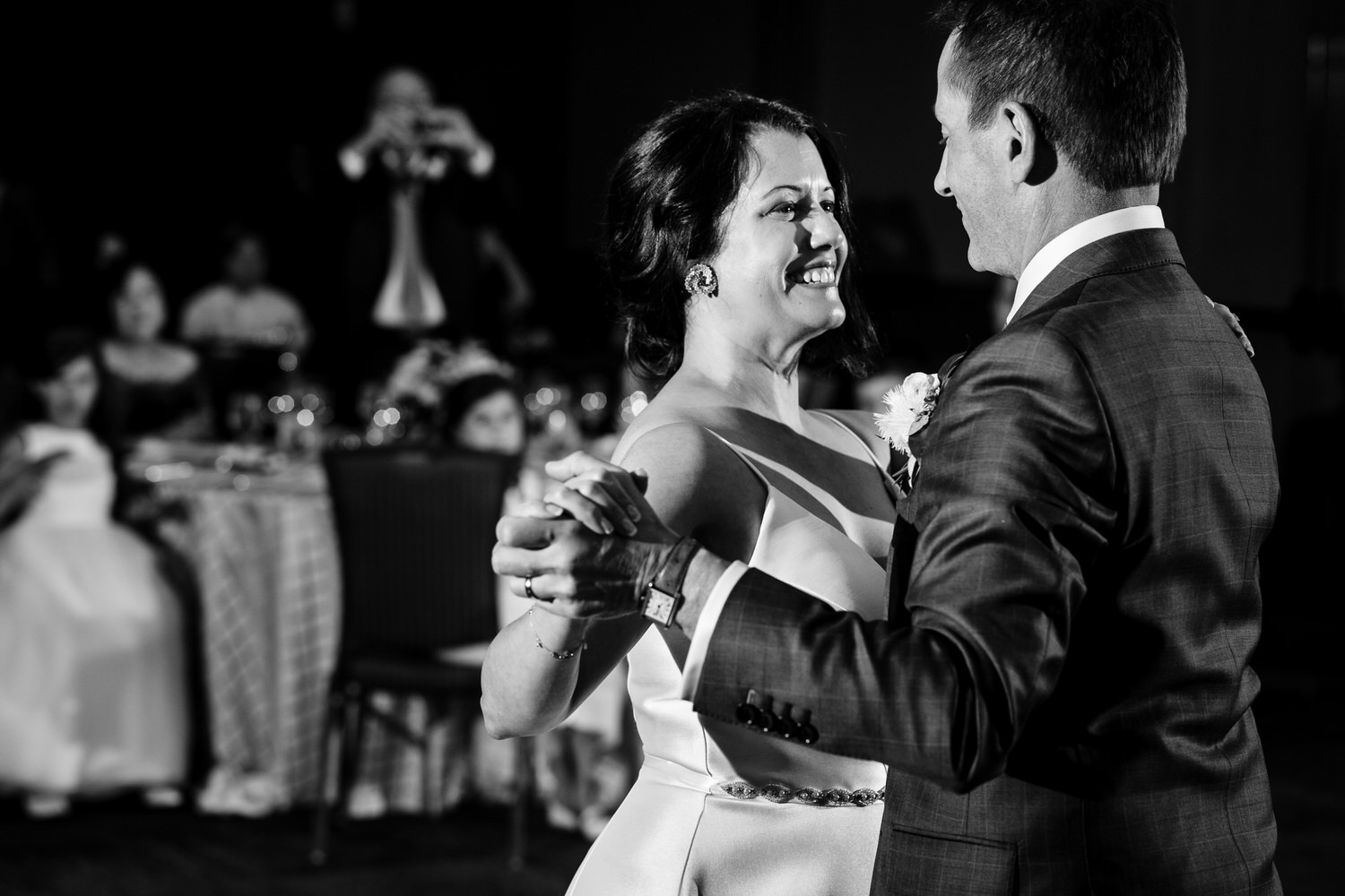 At their Ritz Carlton wedding reception, a bride and groom enjoy their first dance together.