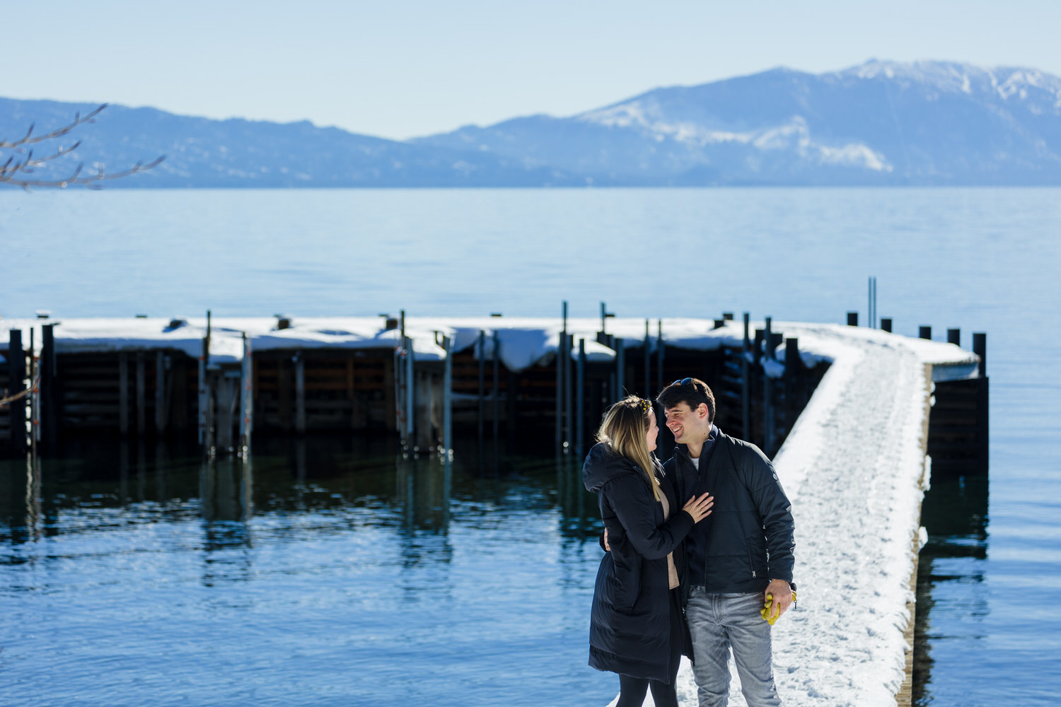 Winter engagement photo in front of Lake Tahoe.