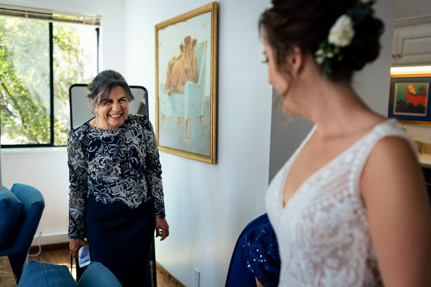 Mother of the groom wearing a navy blue and white dress.