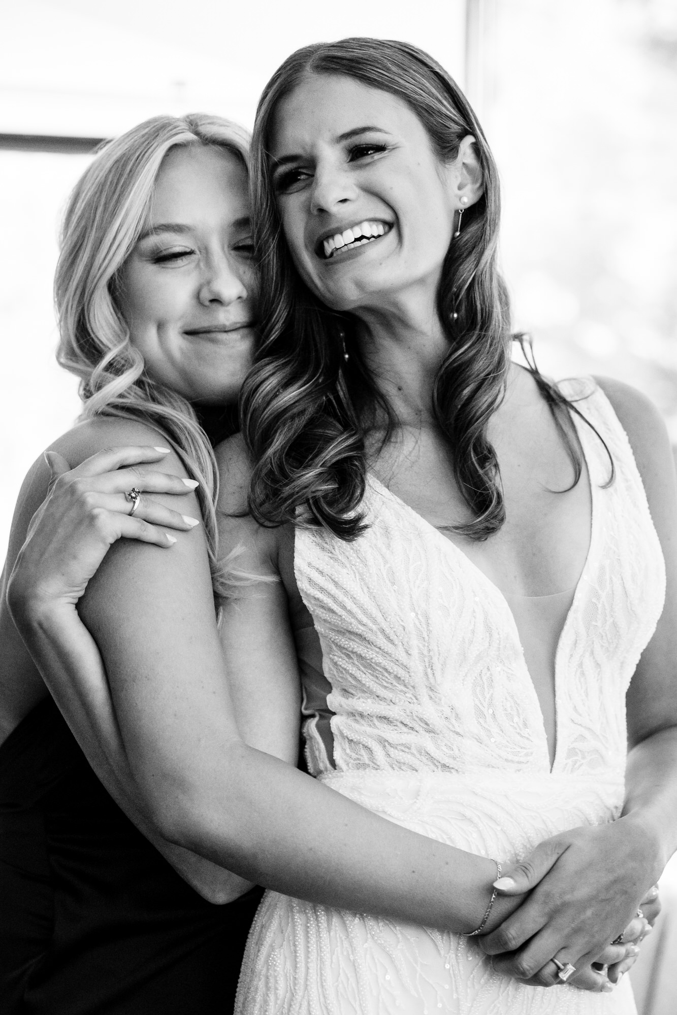 Bride and her bridesmaid share a special moment together before the wedding.