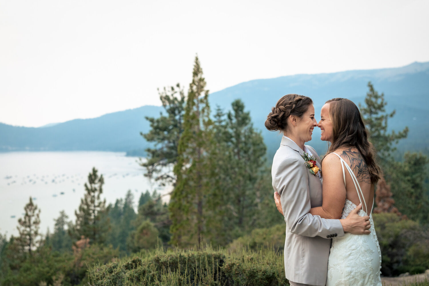 Two brides at their wedding venue overlooking Lake Tahoe.