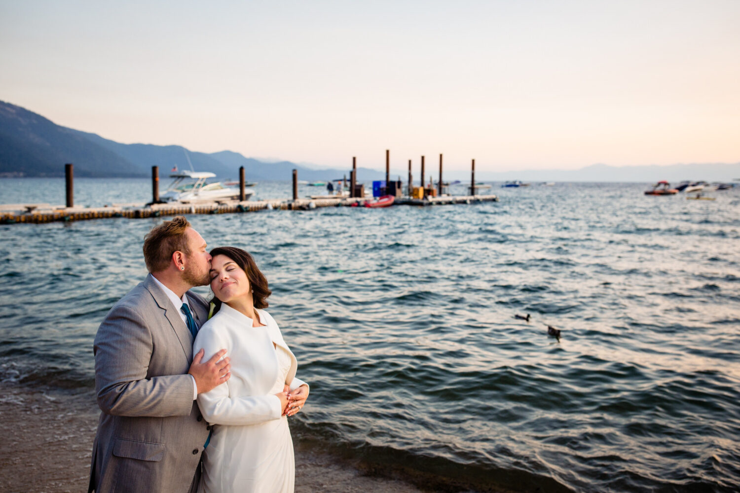 A lakeside kiss at sunset for a couple who decided to get married at the Hyatt Regency Lake Tahoe Resort.