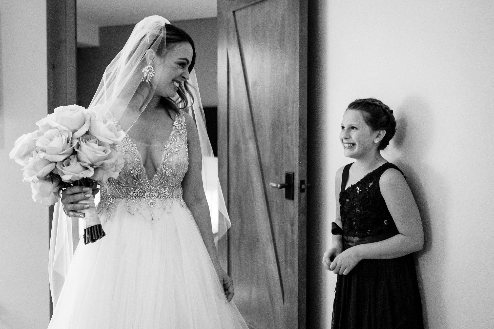 Bride and flower girl looking at each other.