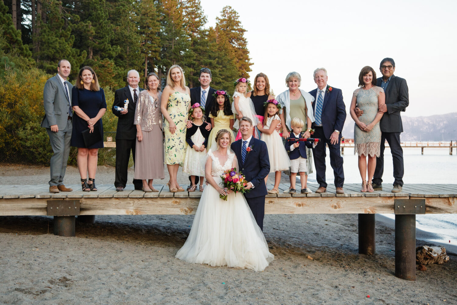 A couple that decided to get married on a dock in Lake Tahoe poses with their families.