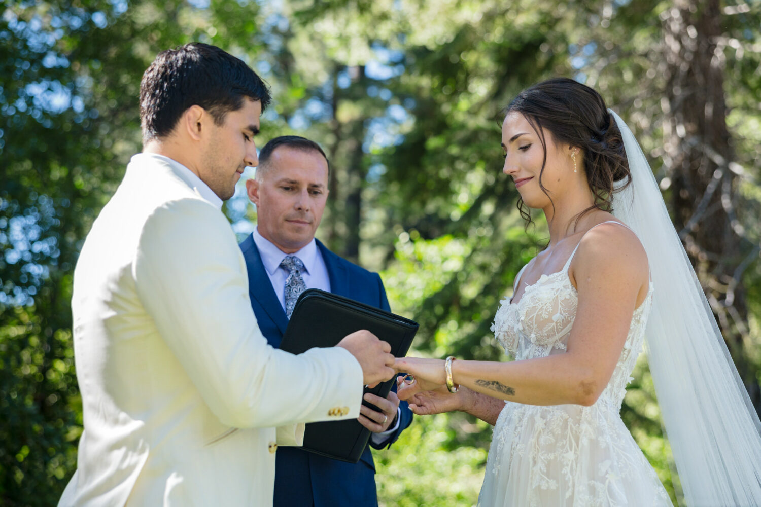 Exchanging rings at a summer wedding at Aspen Grove in Incline Village.
