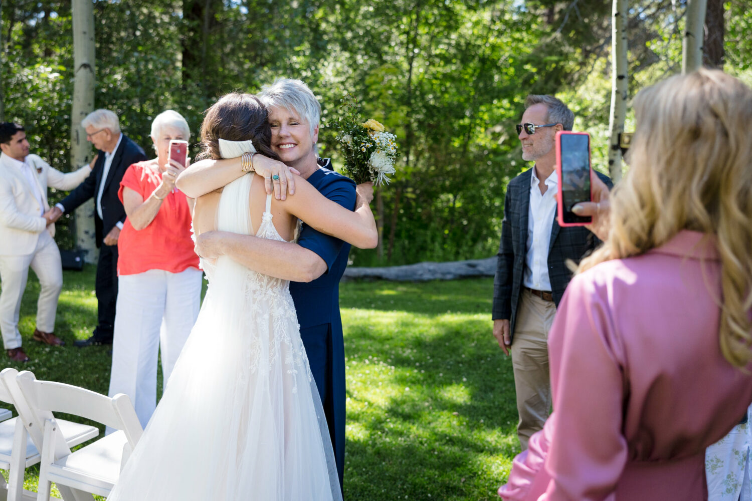 Family members use an iPhone to photograph a wedding.