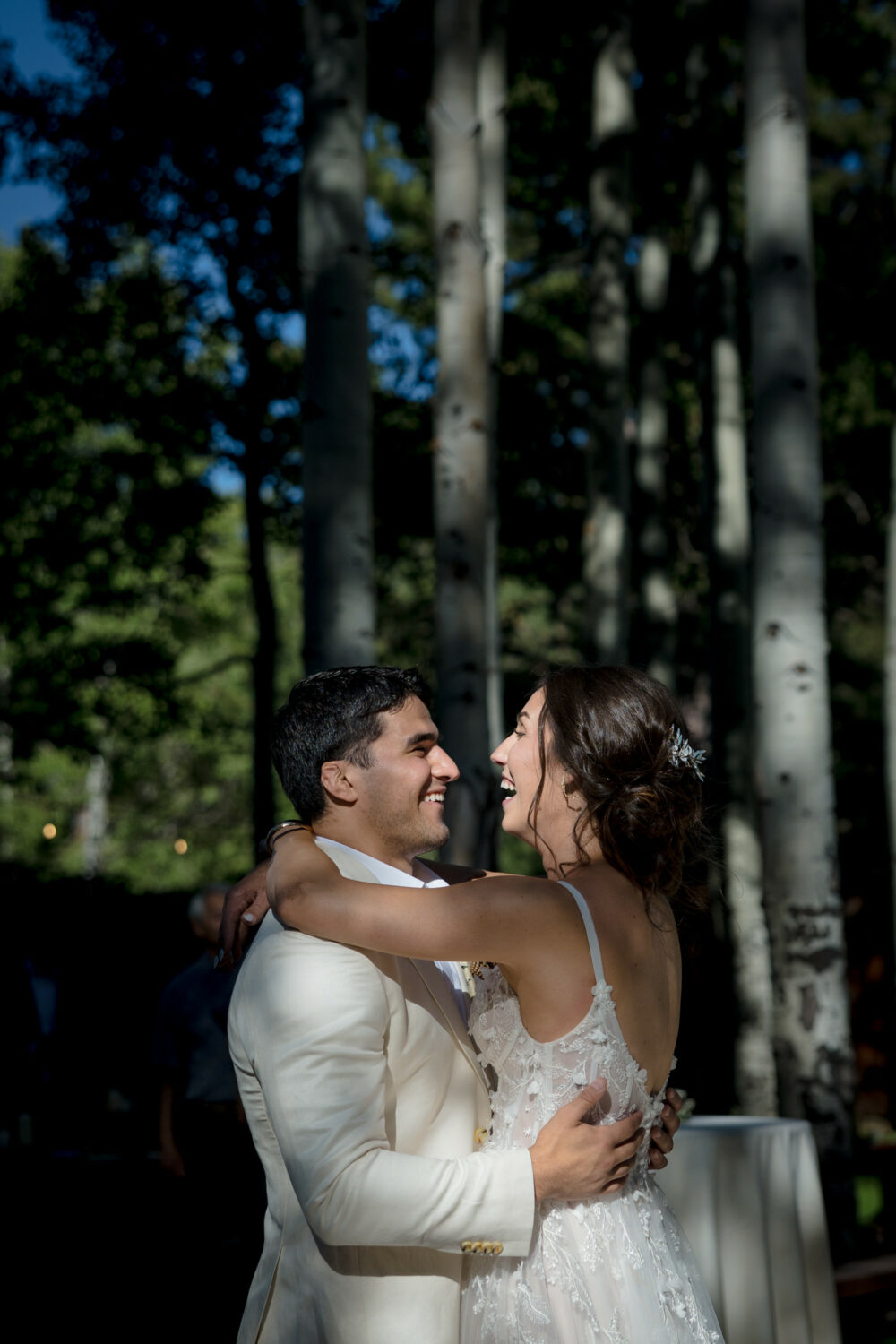Dappled sunlight on a bride and groom at their Aspen Grove wedding.