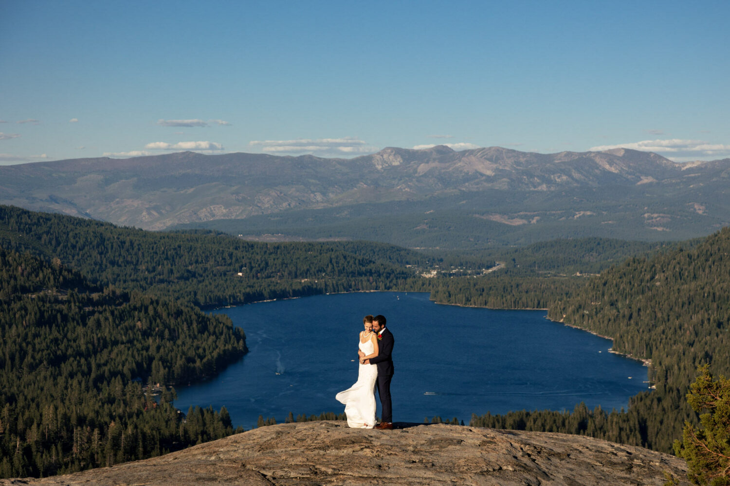 Bride and groom portraits on Donner Summit with Donner Lake in the background.