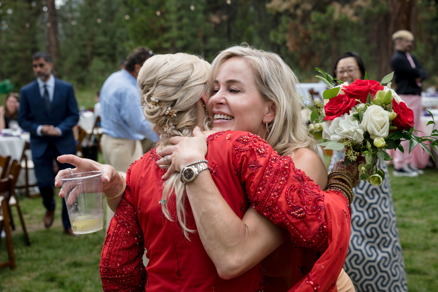 Hugs from a wedding guest at a reception on the lawn at Valhalla Tahoe.