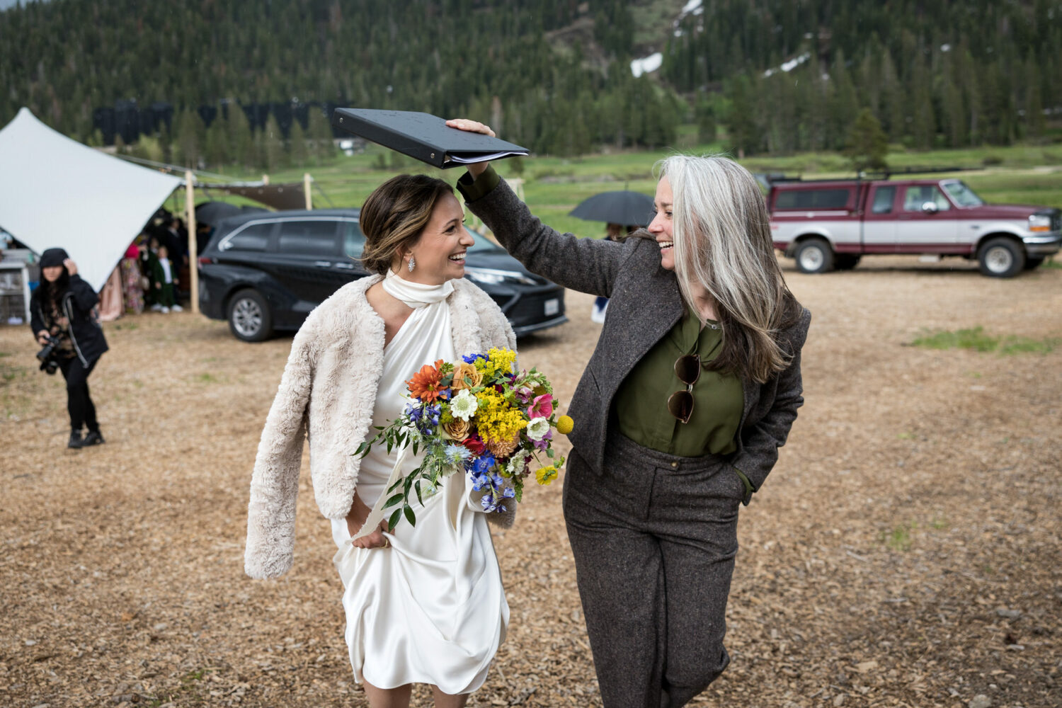 A Lake Tahoe woman rabbi covers the bride's head with a 3-ring binder.