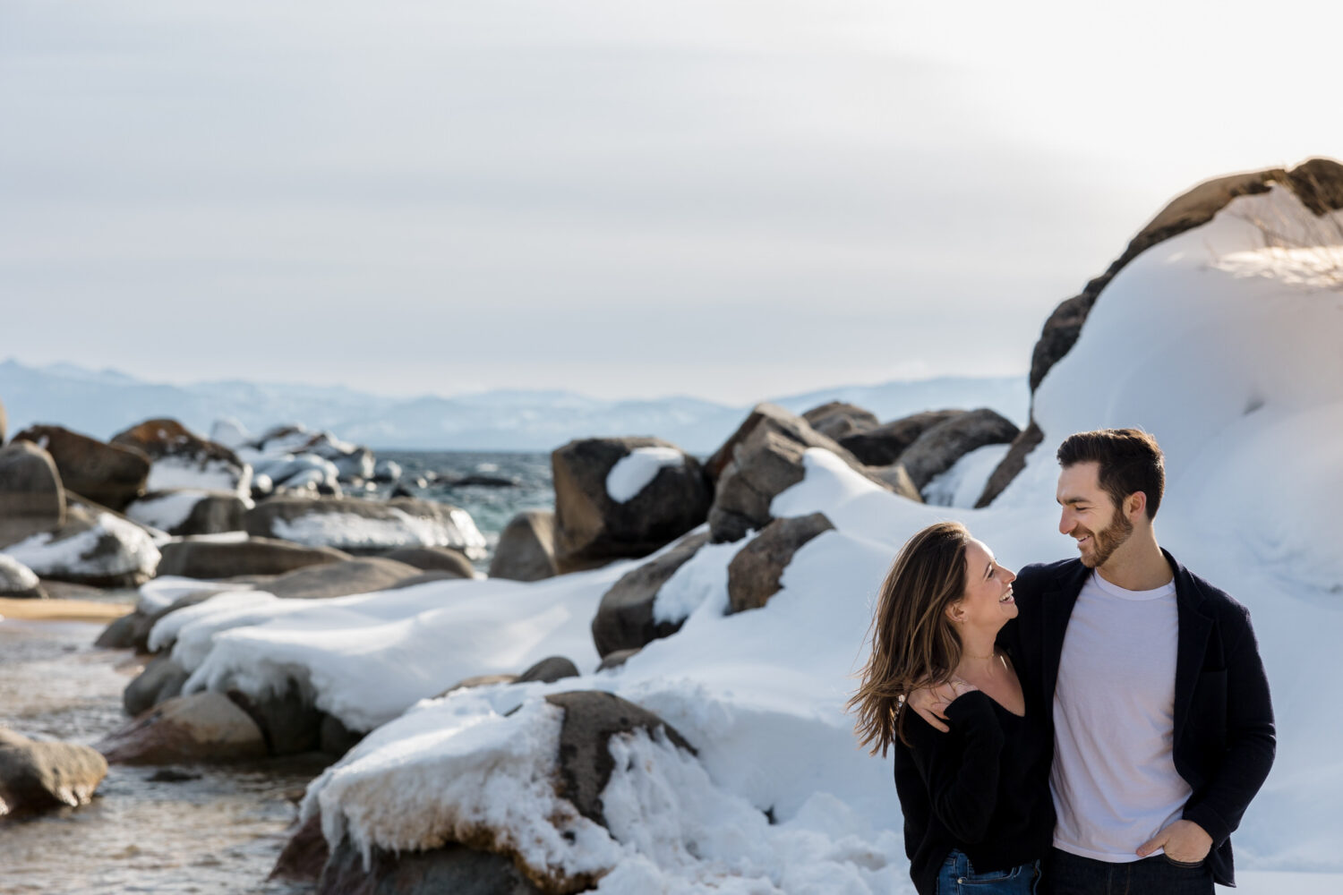 Fun winter engagement session by Lake Tahoe on the beach.