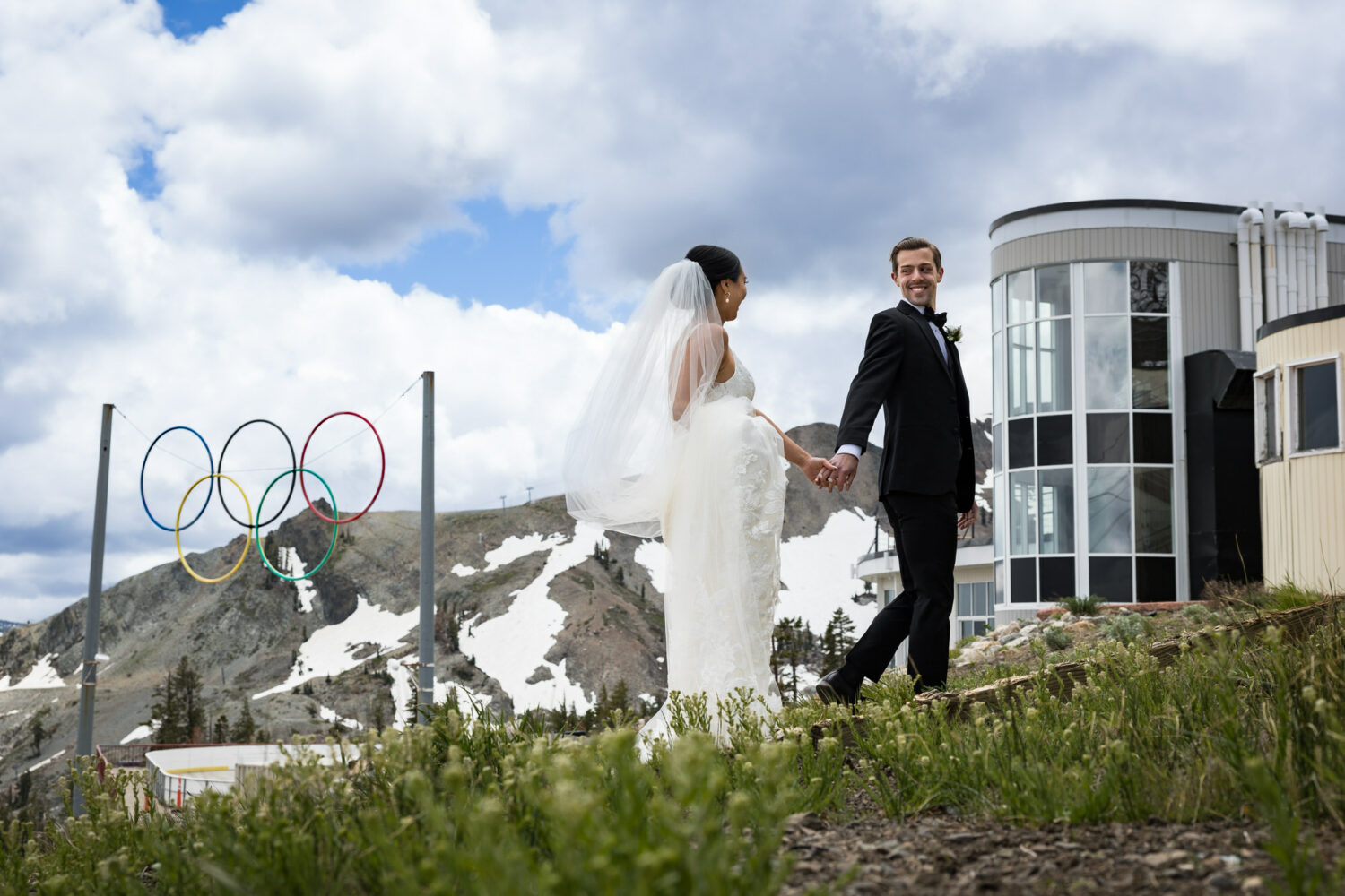 A groom smiles at his bride at their Palisades Tahoe wedding.