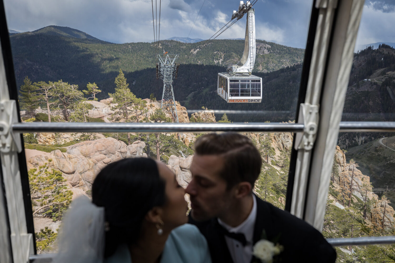 A bride and groom ride the Palisades Tahoe Aerial Tram before their wedding.