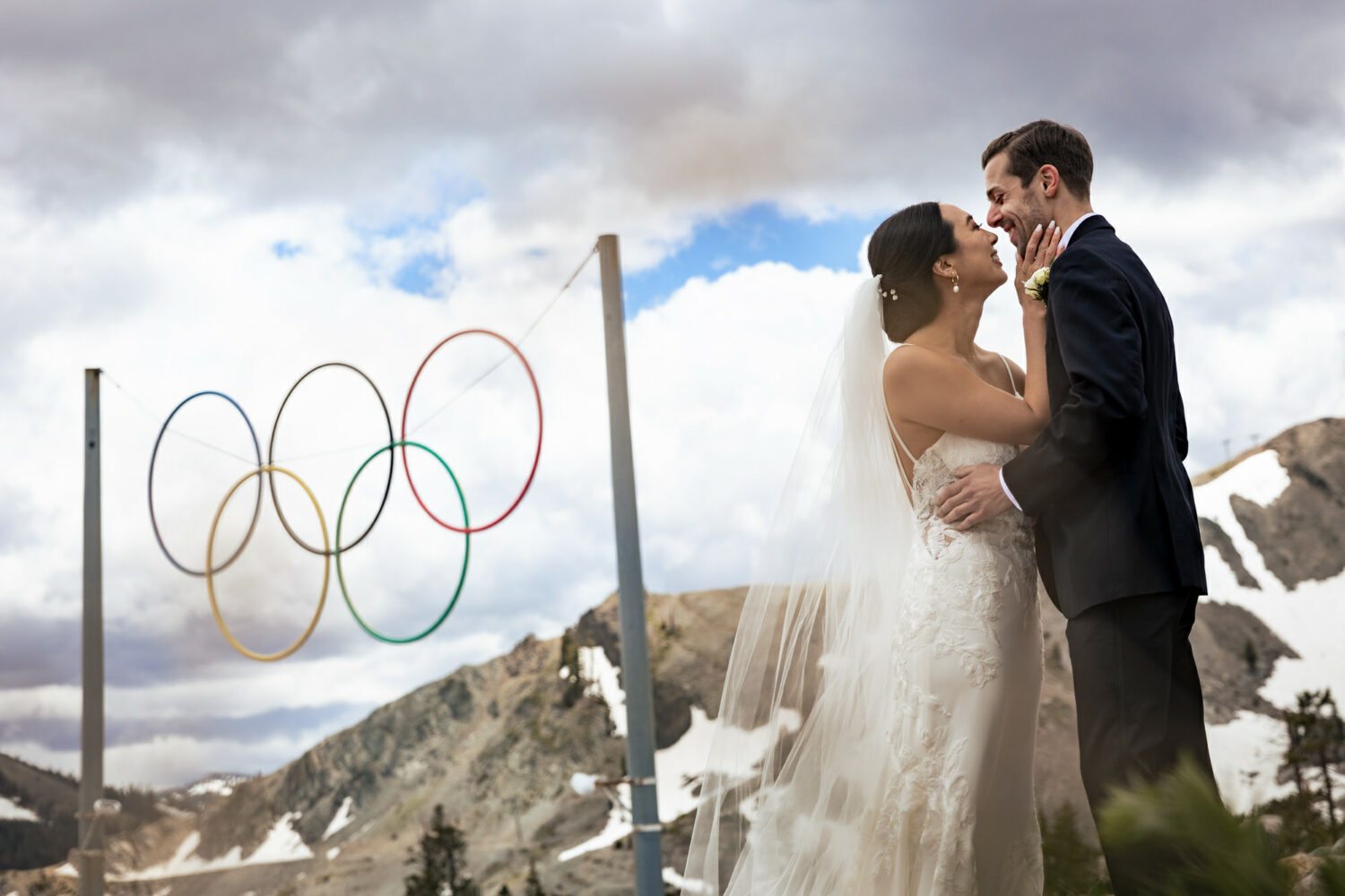 A bride and groom that chose to get married in Olympic Valley share a special moment in front of the Olympic rings.