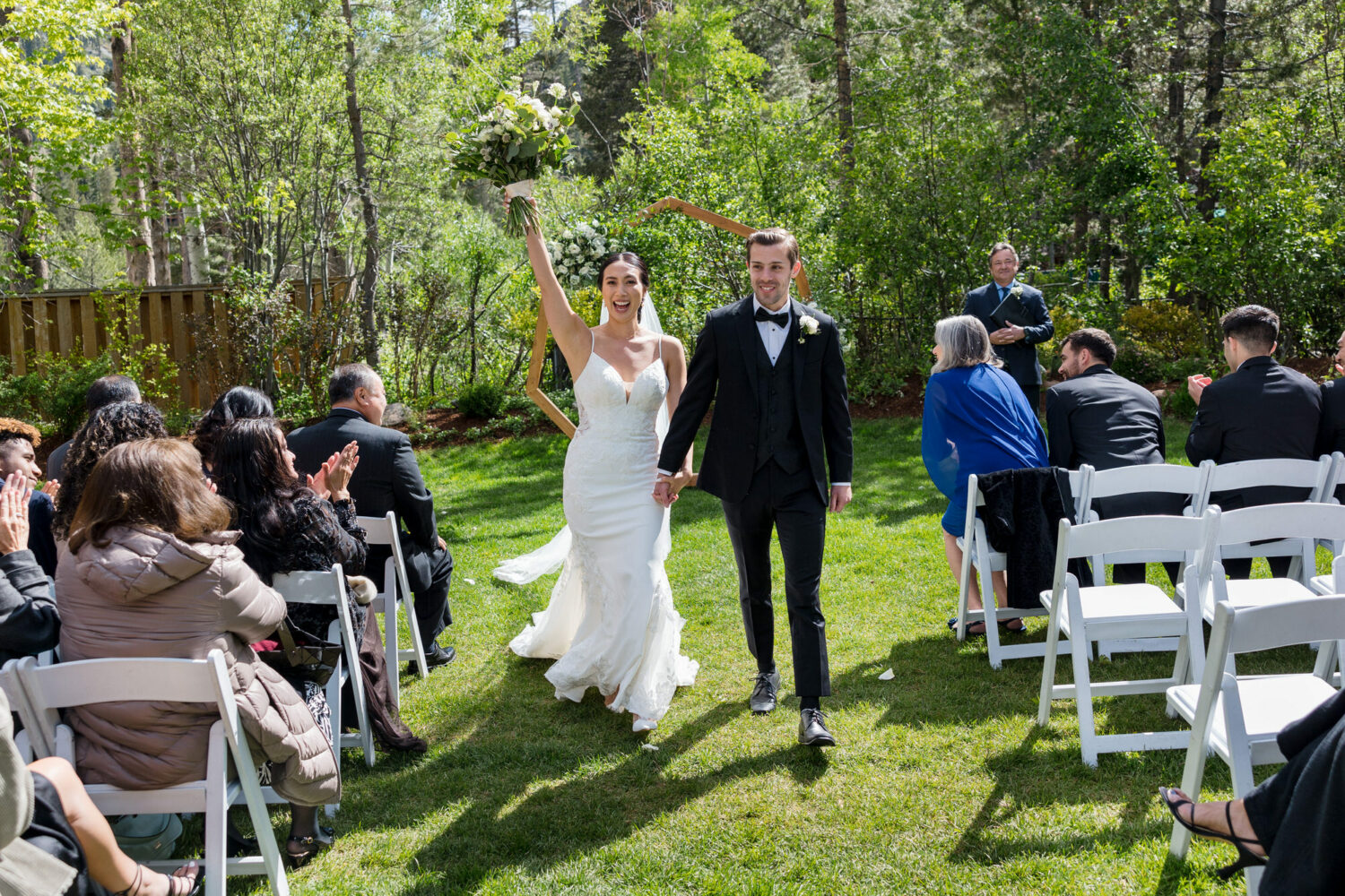 Walking down the aisle after getting married at Palisades Tahoe event center.