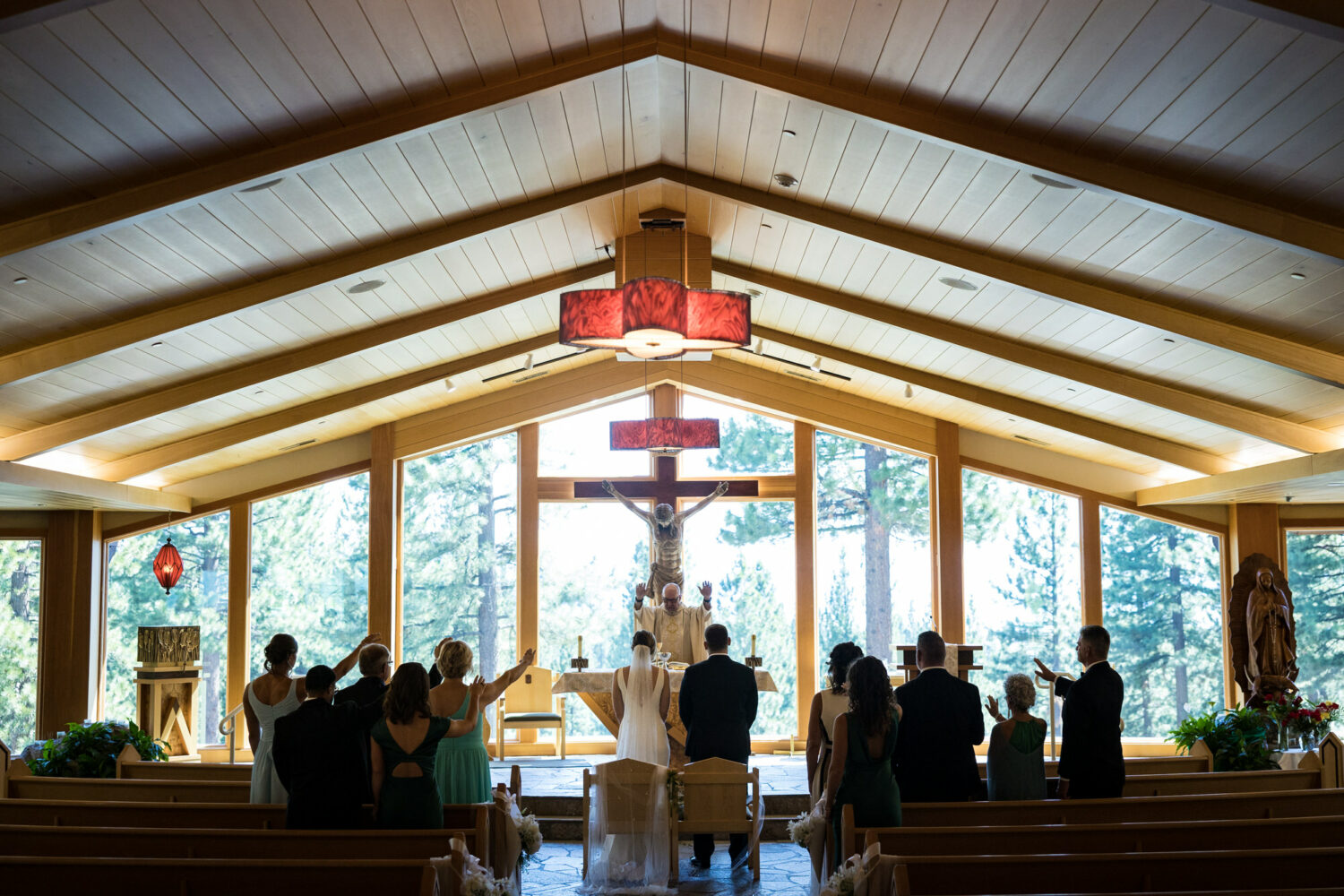 The congregation blesses a bride and groom during a Catholic wedding at St Francis of Assisi church in Lake Tahoe.