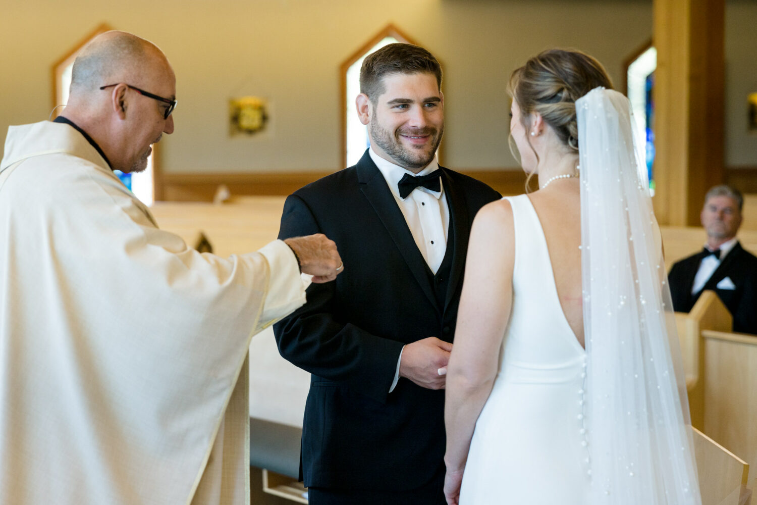 A groom and groom exchange vows at their Catholic Lake Tahoe wedding.