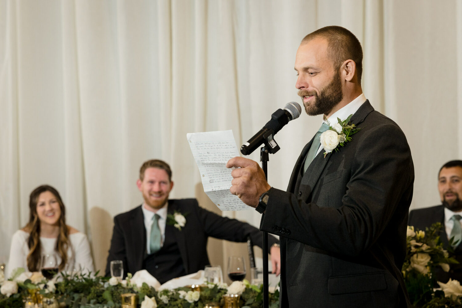 A groomsman makes a champagne toast in the Grand Sierra Ballroom.