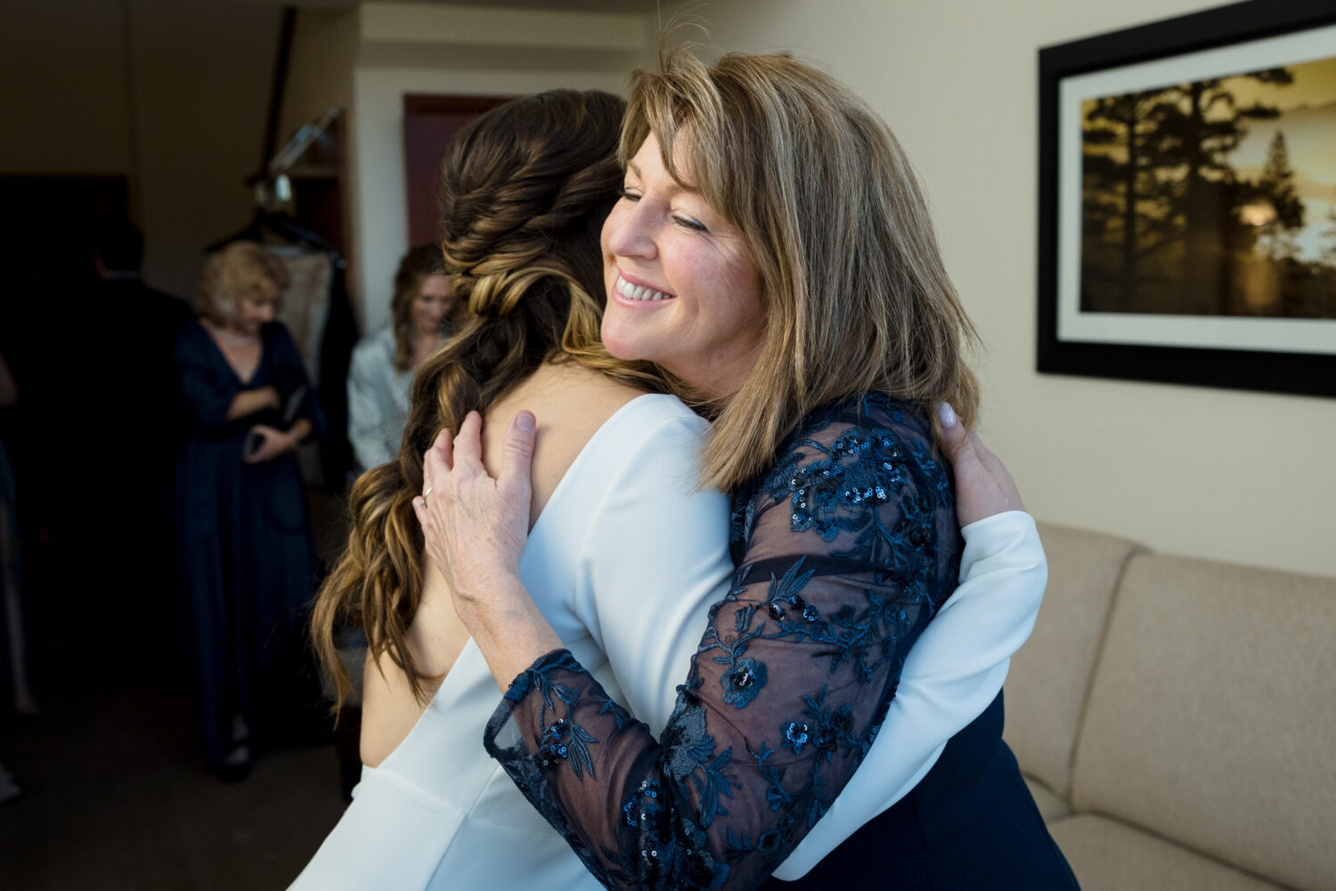 The bride and her mother share a special moment in an Everline Resort hotel room.