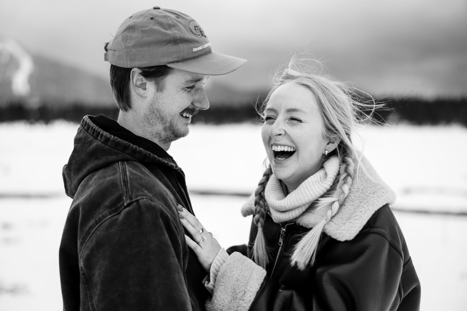 A joyful moment during a surprise wedding proposal in Lake Tahoe during winter.