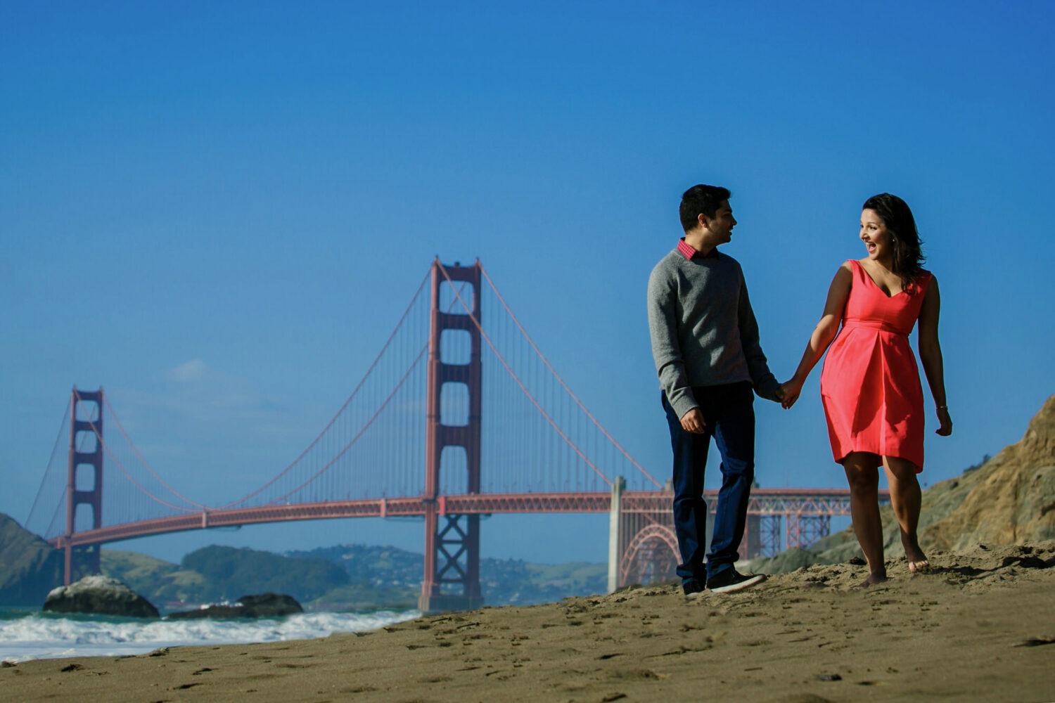 Baker Beach engagement photoshoot in front of the Golden Gate Bridge.