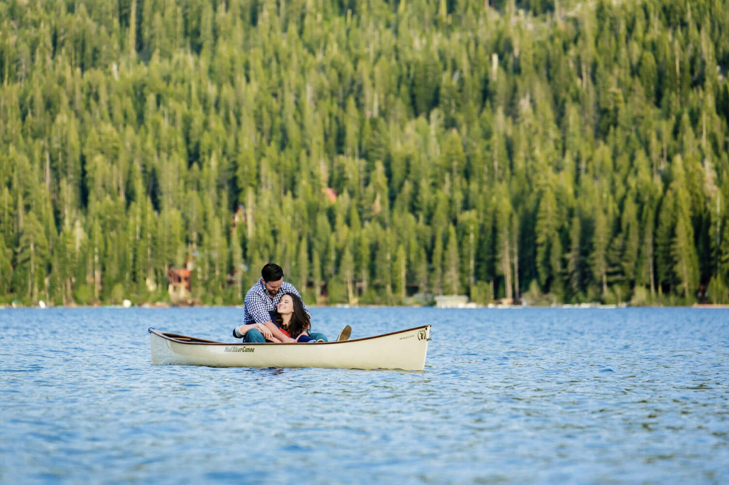 A couple enjoys a quiet moment during their Lake Tahoe canoe engagement photo session.
