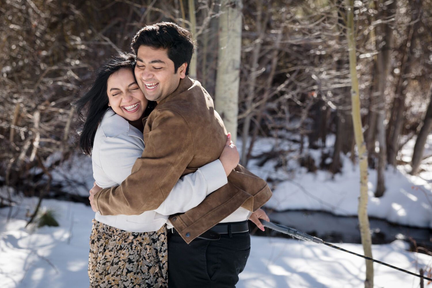A couple embraces at a snowy engagement photoshoot in Lake Tahoe.