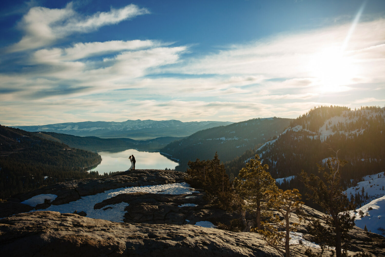 A bride and groom eloping on a mountaintop in Lake Tahoe on Valentine's Day at sunrise.