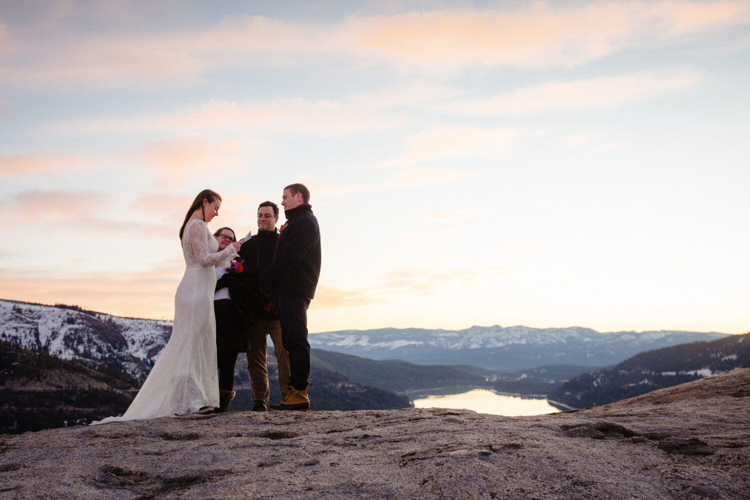 Exchanging vows during a wedding in Lake Tahoe on top of a mountain.
