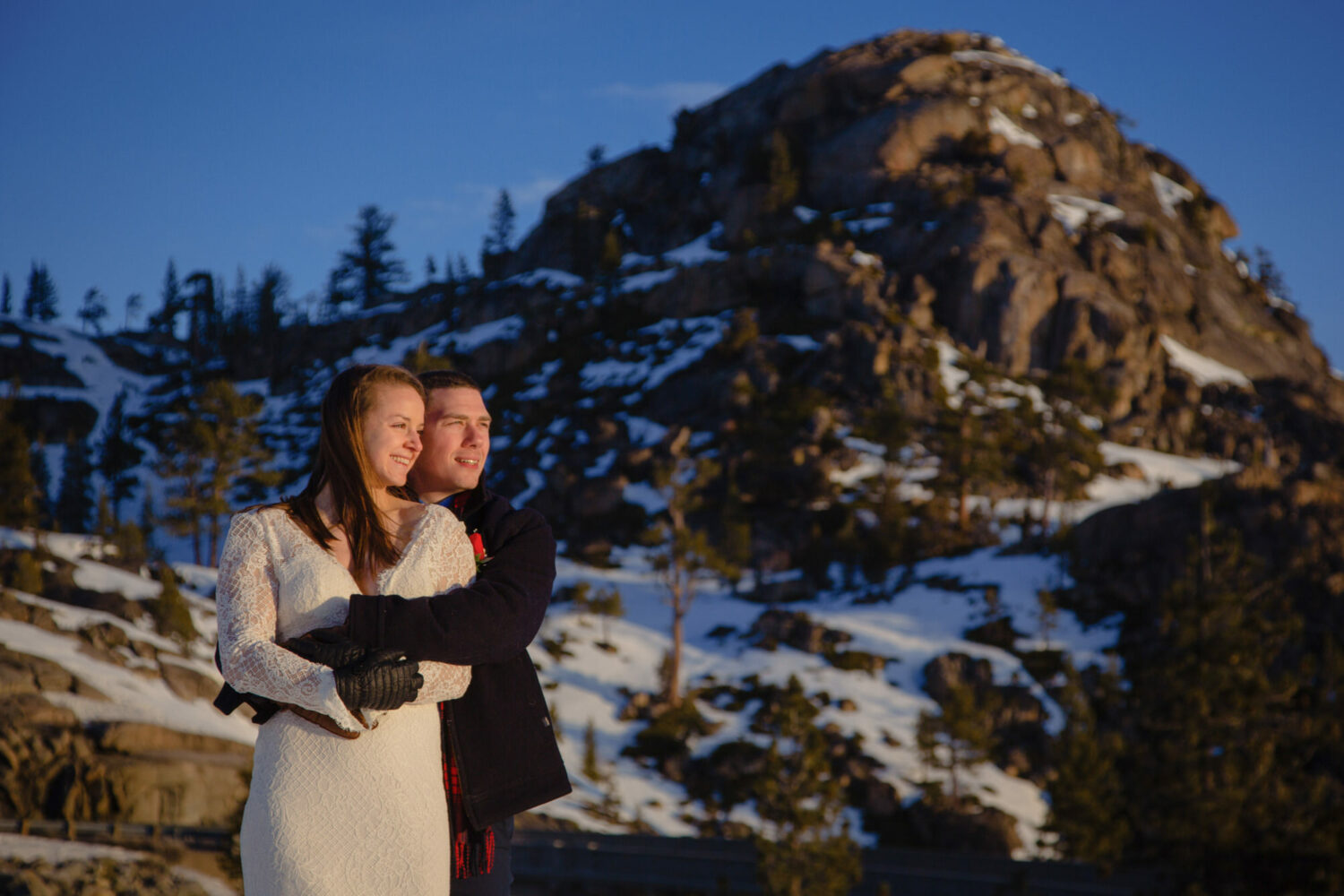 A couple watches the sunrise during their Lake Tahoe elopement photoshoot.
